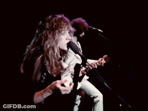 Man Playing Guitar Woman Singing Into Microphone GIF