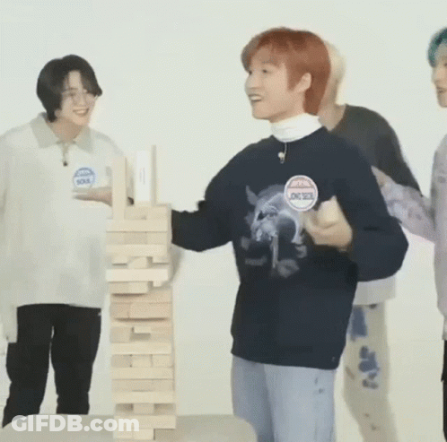 Man Playing Jenga With Young Men GIF