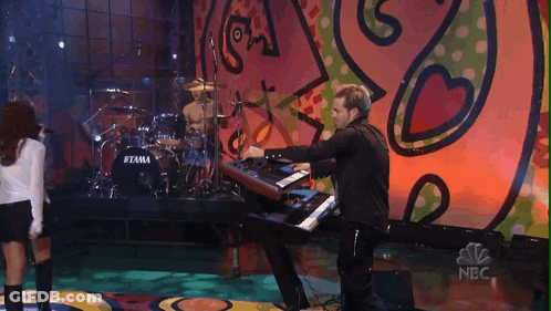 Man Playing Keyboard In Front Of Tama Drum Set GIF