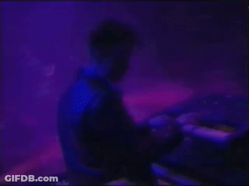 Man Playing Keyboard On Stage With Blue Light GIF