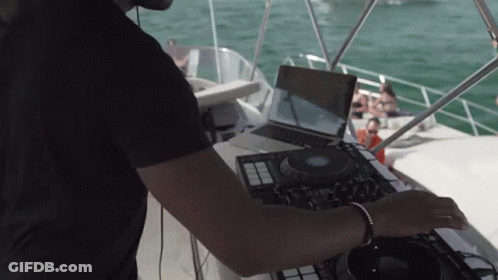Man Playing Music On Boat With Laptop GIF