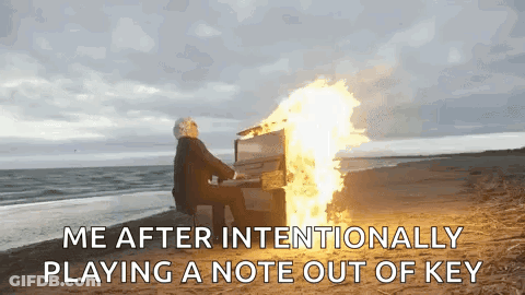 Man Playing Piano On Beach With Fire GIF