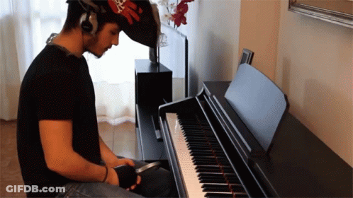 Man Playing Piano With Headphones GIF