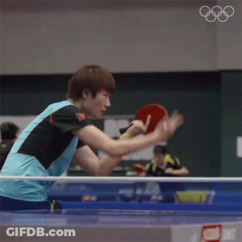 Man Playing Ping Pong With Olympic Rings GIF