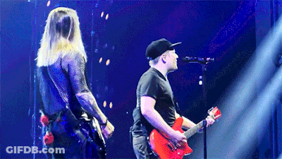 Man Playing Red Guitar On Stage With Singer GIF