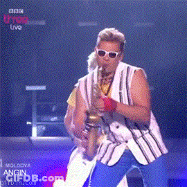Man Playing Saxophone In Front Of BBC U-Top Live Screen GIF