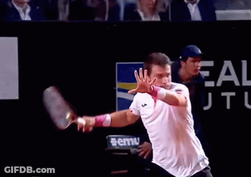 Man Playing Tennis In Front Of Ale Sign GIF