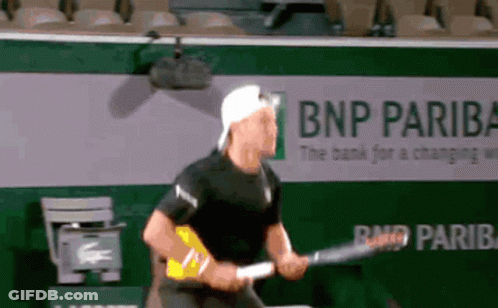 Man Playing Tennis In Front Of BNP Pariba Ad GIF