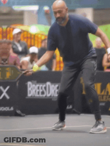 Man Playing Tennis In Front Of Brees Dre Ad GIF