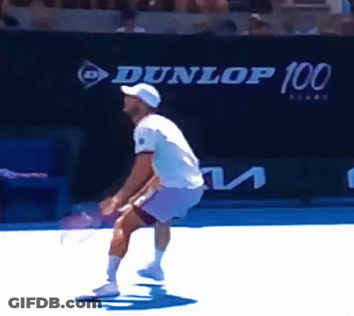 Man Playing Tennis In Front Of Dunlop 100 Sign GIF