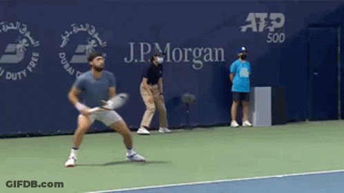 Man Playing Tennis In Front Of J.P. Morgan Banner GIF