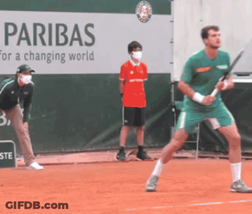 Man Playing Tennis In Front Of Paribas Banner GIF