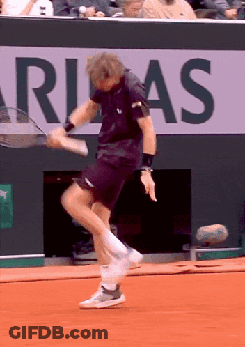 Man Playing Tennis In Front Of Rias Sign GIF