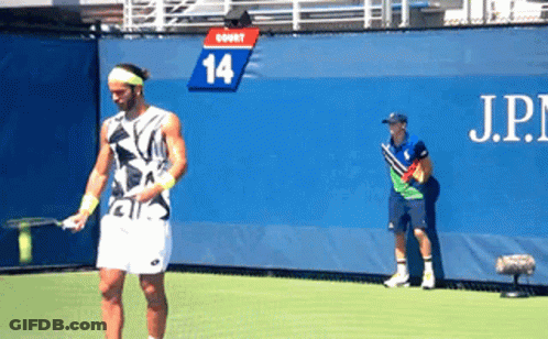 Man Playing Tennis In Front Of Wall With Number 14 GIF