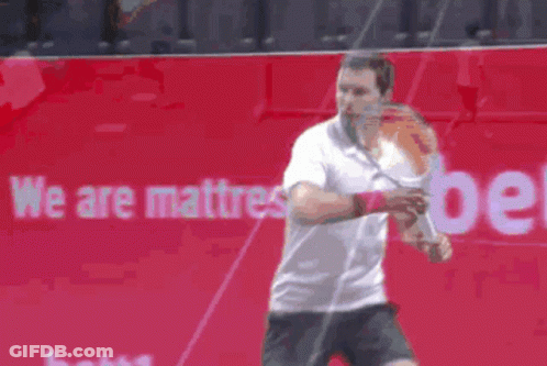 Man Playing Tennis In Front Of We Are Mattress Ad GIF