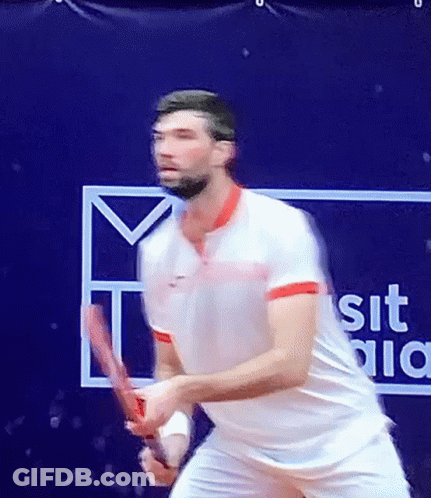 Man Playing Tennis Next To Sit Sign GIF