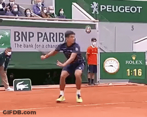 Man Playing Tennis On Clay Court In Front Of BNP Pariba Ad GIF