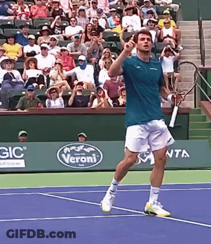 Man Playing Tennis On Court With Veroni Sign GIF