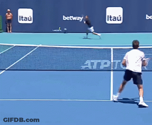 Man Playing Tennis With Itau Ads Behind GIF