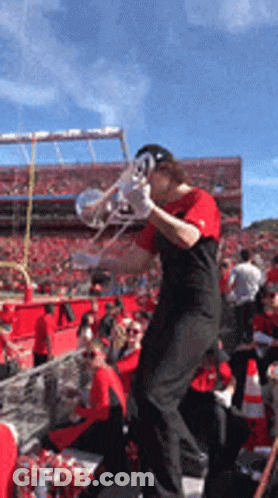 Man Playing Trumpet At Football Game GIF