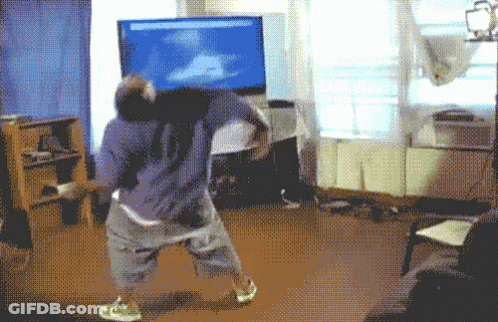 Man Playing Video Game On Large Flat Screen TV GIF