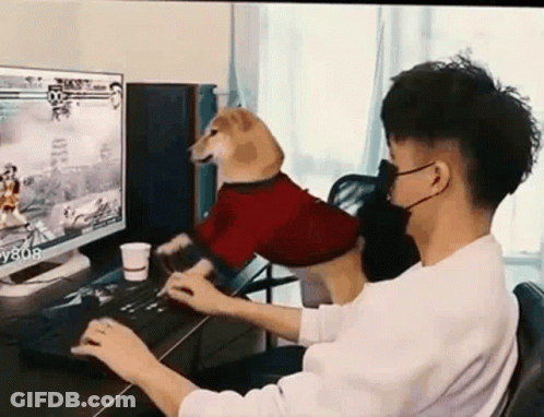 Man Playing Video Game With Dog On Lap GIF