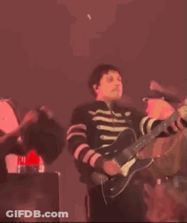 Man Playing Violin On Stage In Dark Room GIF