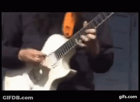 Man Playing White Electric Guitar With Orange Tie GIF