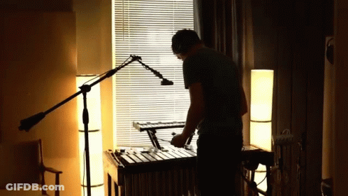 Man Playing Xylophone In Dark Room GIF