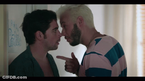 Man Pointing At Another Man's Nose In Front Of Pepsi Wall GIF