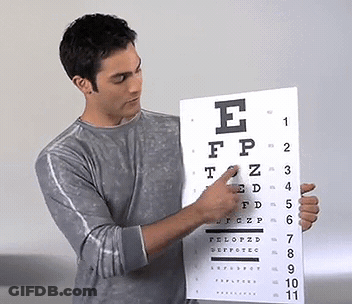 Man Pointing At Eye Chart With Letter E GIF