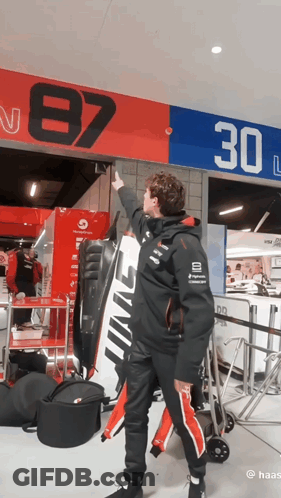Man Pointing At Sign Saying 87 30 GIF