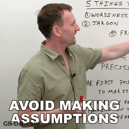 Man Pointing At Whiteboard Saying Avoid Making Assumptions GIF