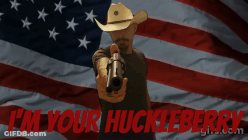 Man Pointing Gun In Front Of American Flag Saying I'm Your Huckleberry GIF