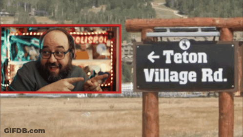 Man Points To Sign Saying Teton Village Road GIF