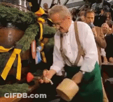 Man Pouring Beer Into Barrel While Crowd Watches GIF