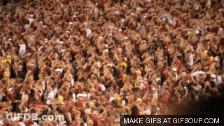 Man Pouring Beer Into Bucket While Group Sits On Lawn GIF