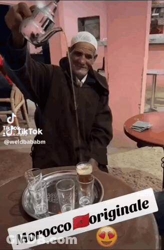 Man Pouring Drink From Teapot With Morocco Originale Sign GIF