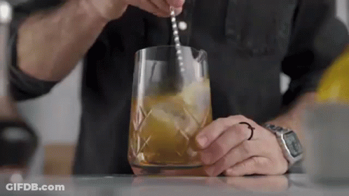 Man Pouring Drink Into Glass With Spoon GIF