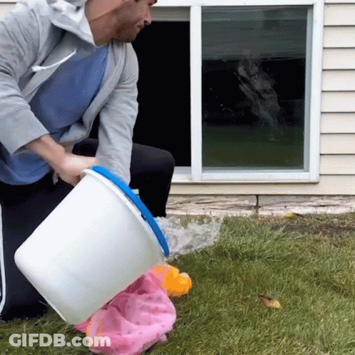 Man Pouring Water From White Bucket Into Pink Towel GIF