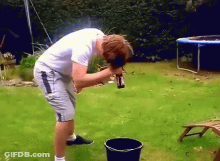 Man Pouring Water Into Black Bucket In Backyard GIF