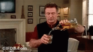 Man Pouring Whiskey From Bottle Into Glass GIF