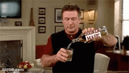 Man Pouring Whiskey Glass In Living Room GIF