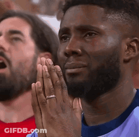 Man Praying While Watching Game GIF