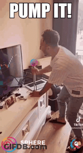 Man Pumps Lollipop In Front Of Computer With Sphere Finance Logo GIF