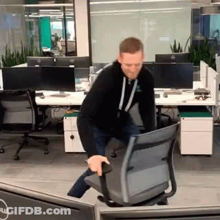 Man Pushing Chair In Office With Dell Monitor GIF
