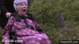 Man Pushing Elderly Woman In Pink Dress In Wheelchair GIF