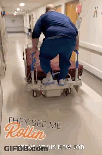 Man Pushing Hospital Bed With They See Me Rollin Steve GIF