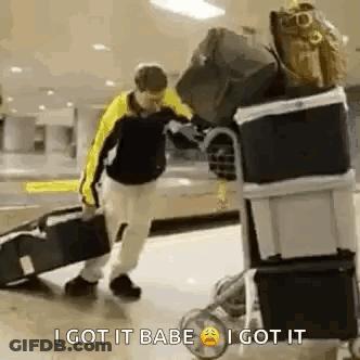 Man Pushing Luggage Cart Saying I Got It Babe GIF
