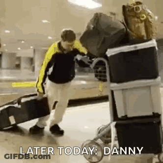 Man Pushing Luggage Cart With Suitcase GIF